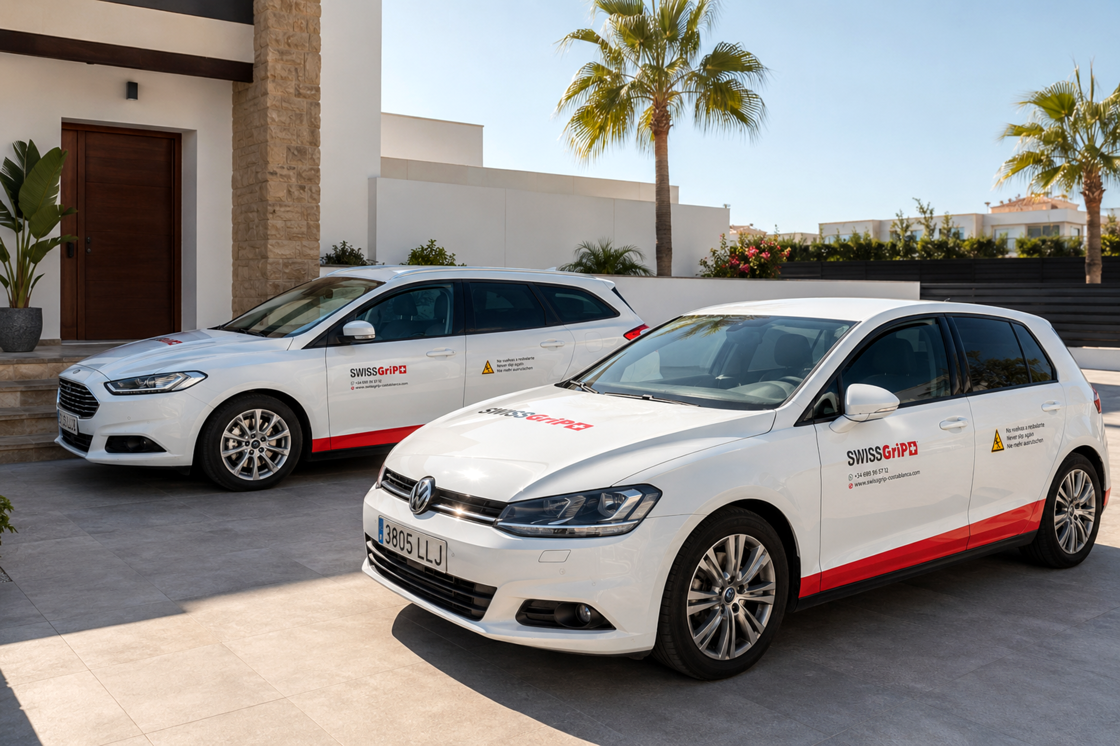 Two SWISSGriP Costa Blanca branded company vehicles parked outside a client villa